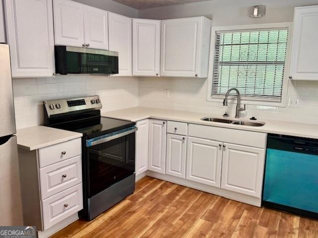 3988 Chimney Ridge Dr, Ellenwood, GA 30294 - kitchen with a sink, stainless steel appliances, white cabinetry, light countertops, and tasteful backsplash