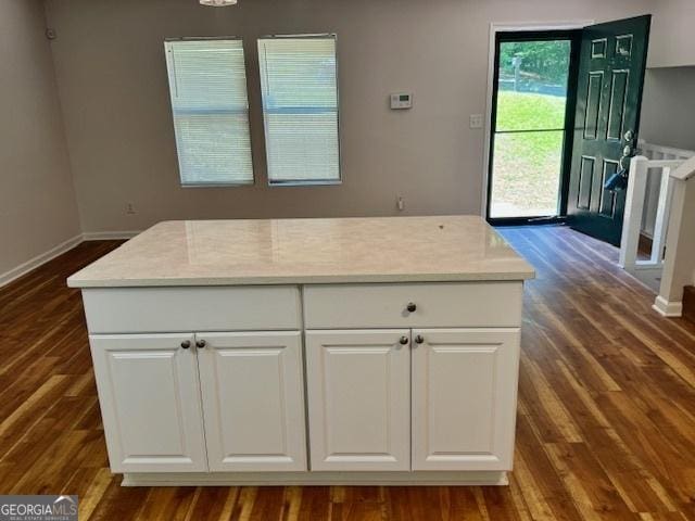 3988 Chimney Ridge Dr, Ellenwood, GA 30294 - kitchen with baseboards, light countertops, white cabinets, and dark wood-type flooring
