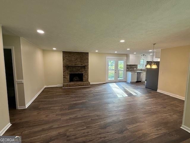 unfurnished living room featuring baseboards, a fireplace, recessed lighting, and dark wood-style floors