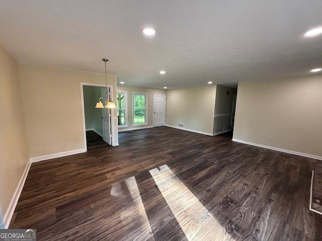 interior space featuring dark wood-style flooring, baseboards, and recessed lighting