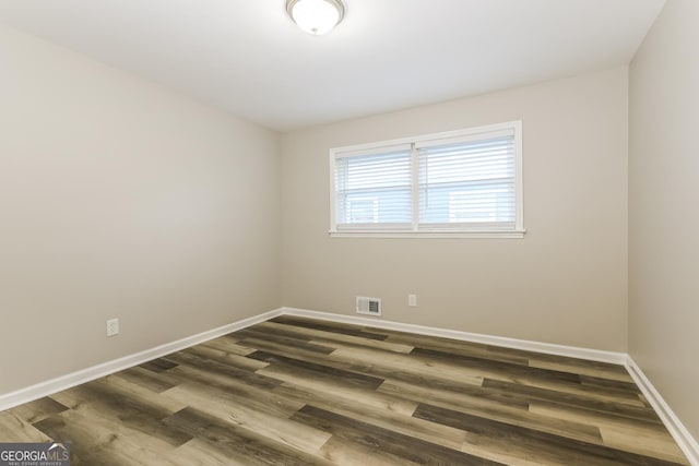 338 Mount Zion Rd, Hapeville, GA 30354 - spare room with baseboards, dark wood-style flooring, and visible vents