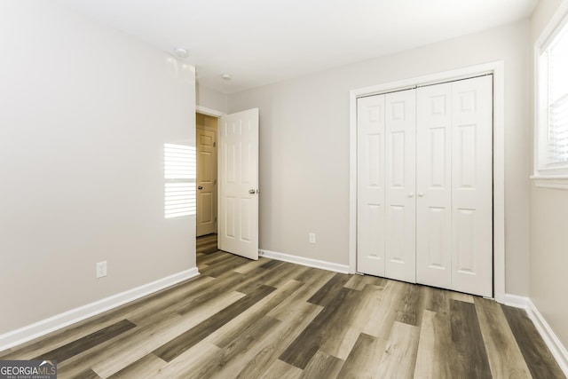 338 Mount Zion Rd, Hapeville, GA 30354 - unfurnished bedroom featuring baseboards, a closet, and wood finished floors