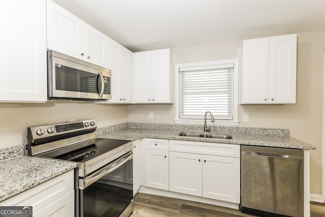 338 Mount Zion Rd, Hapeville, GA 30354 - kitchen featuring white cabinetry, appliances with stainless steel finishes, dark wood-style flooring, and a sink
