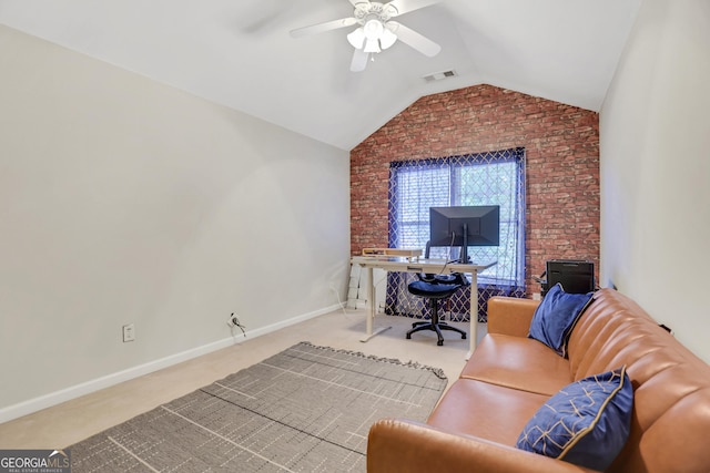 carpeted office featuring visible vents, vaulted ceiling, ceiling fan, brick wall, and baseboards