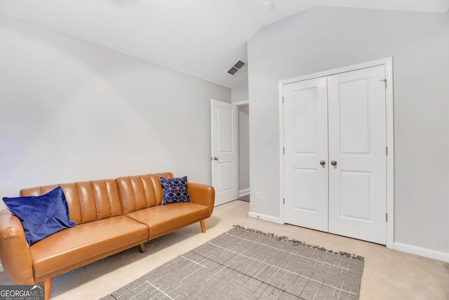 living area with lofted ceiling, light carpet, visible vents, and baseboards