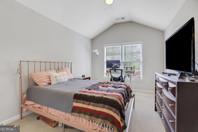 bedroom featuring baseboards, visible vents, light colored carpet, and vaulted ceiling