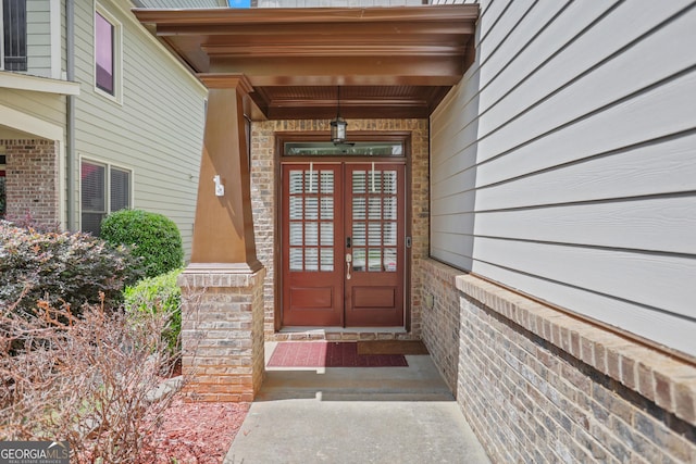 view of exterior entry with french doors and stone siding