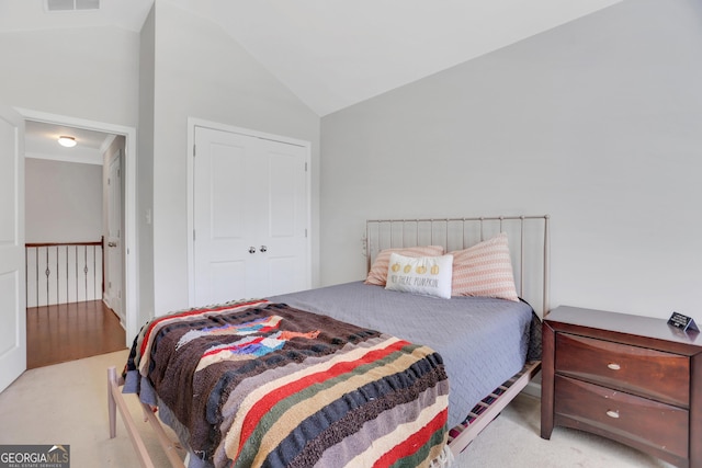 carpeted bedroom with visible vents and lofted ceiling