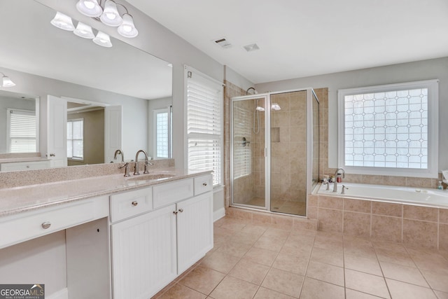 bathroom featuring a stall shower, tile patterned flooring, a bath, and vanity