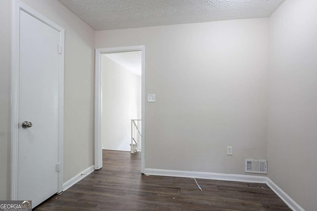 3938 Emerald Springs Ct, Decatur, GA 30035 - spare room with a textured ceiling, baseboards, dark wood-type flooring, and visible vents