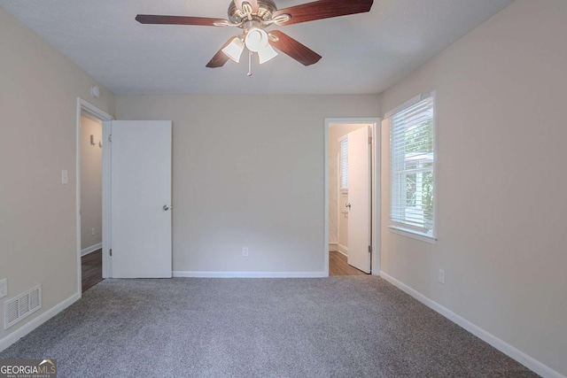 3938 Emerald Springs Ct, Decatur, GA 30035 - unfurnished bedroom featuring visible vents, carpet flooring, a ceiling fan, connected bathroom, and baseboards