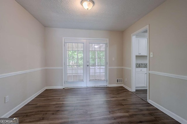 3938 Emerald Springs Ct, Decatur, GA 30035 - spare room featuring dark wood-style floors, a textured ceiling, french doors, and visible vents
