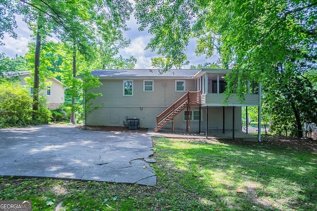 3938 Emerald Springs Ct, Decatur, GA 30035 - rear view of house with stairs, a yard, a patio, cooling unit, and a sunroom