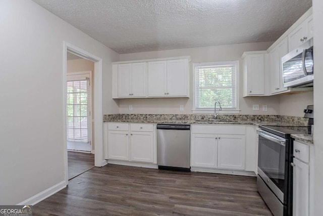 3938 Emerald Springs Ct, Decatur, GA 30035 - kitchen featuring a textured ceiling, stainless steel appliances, white cabinets, and a sink
