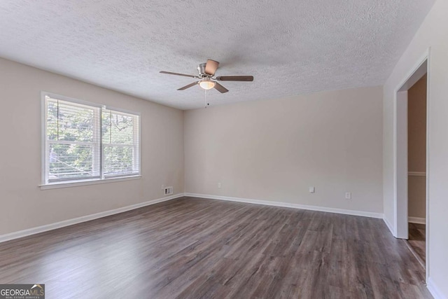 3938 Emerald Springs Ct, Decatur, GA 30035 - empty room featuring a ceiling fan, a textured ceiling, baseboards, dark wood finished floors, and visible vents
