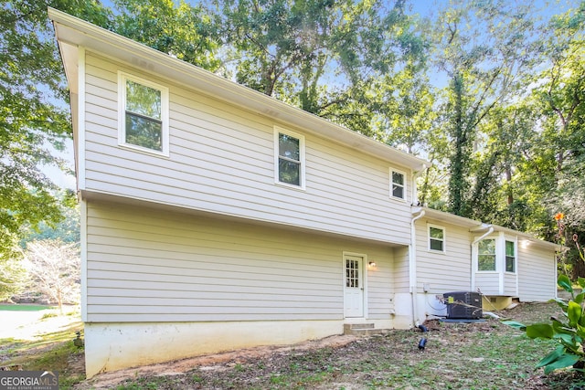 rear view of house with cooling unit