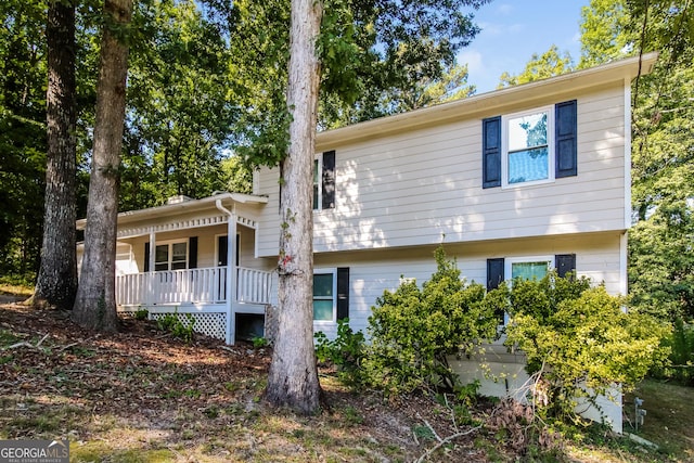 back of house featuring covered porch