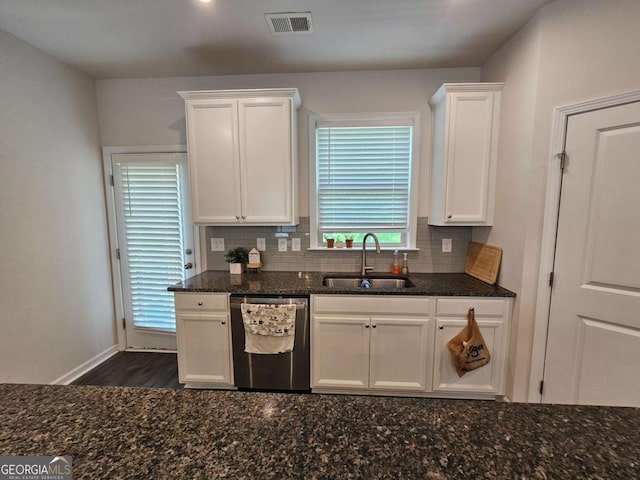 kitchen featuring a sink, white cabinets, visible vents, dishwasher, and tasteful backsplash
