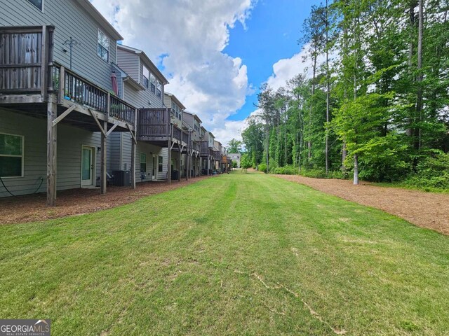 view of yard with a residential view and a wooden deck