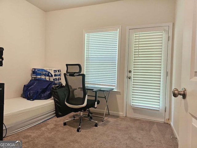 carpeted office space featuring baseboards