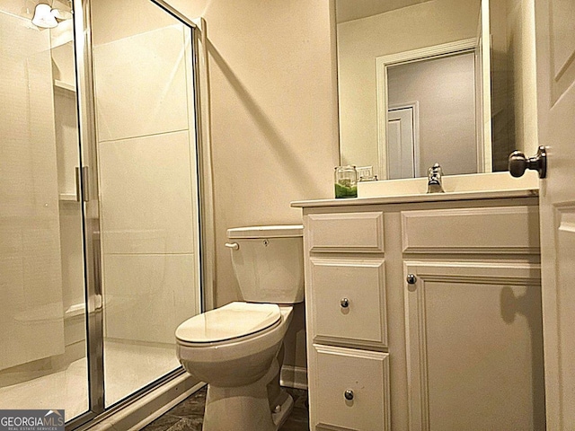 full bath featuring a shower stall, vanity, and toilet