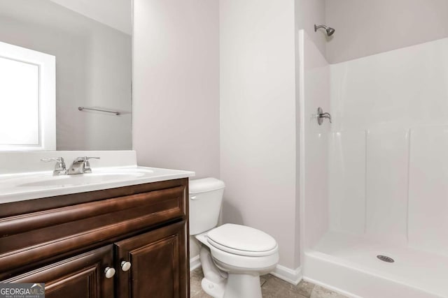 7843 Shertall St, Fairburn, GA 30213 - bathroom featuring toilet, walk in shower, vanity, and tile patterned flooring
