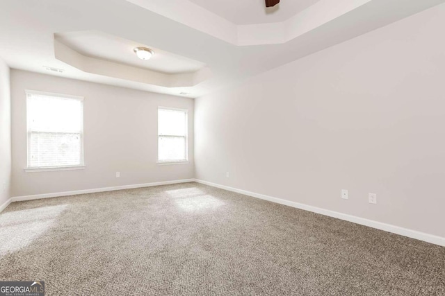 7843 Shertall St, Fairburn, GA 30213 - carpeted empty room featuring baseboards, a tray ceiling, and visible vents