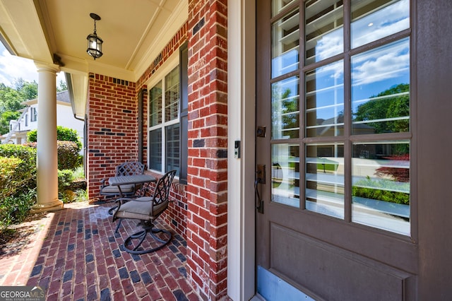621 Oakbourne Way, Woodstock, GA 30188 - view of exterior entry featuring brick siding and a porch