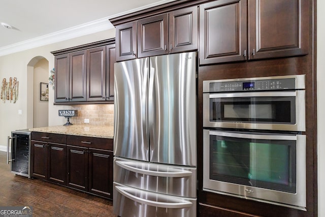 621 Oakbourne Way, Woodstock, GA 30188 - kitchen with stainless steel appliances, beverage cooler, arched walkways, dark brown cabinetry, and tasteful backsplash