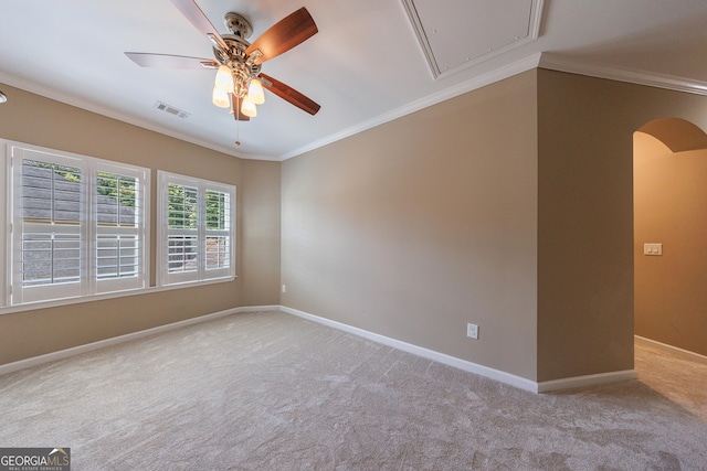 621 Oakbourne Way, Woodstock, GA 30188 - carpeted spare room featuring arched walkways, attic access, crown molding, a ceiling fan, and baseboards