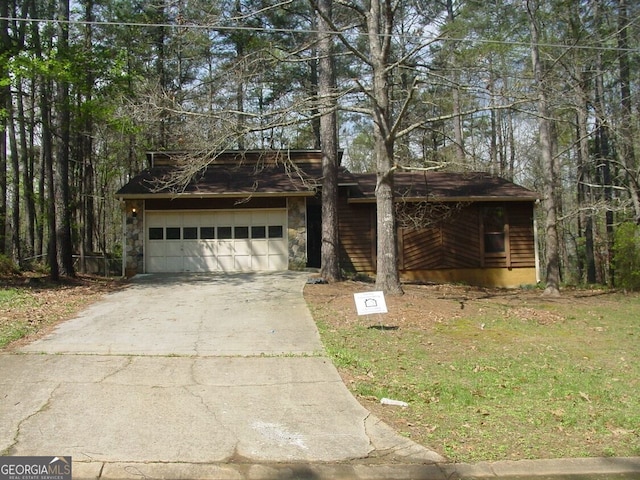 3208 Berrong Way, Stone Mountain, GA 30087 - view of front of home with driveway, stone siding, and a front lawn