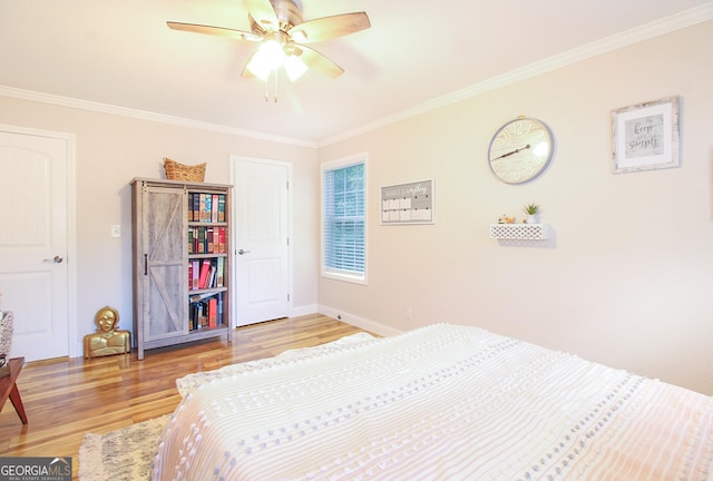1609 Dillard Bray Rd, Royston, GA 30662 - bedroom featuring a ceiling fan, crown molding, light wood-type flooring, and baseboards