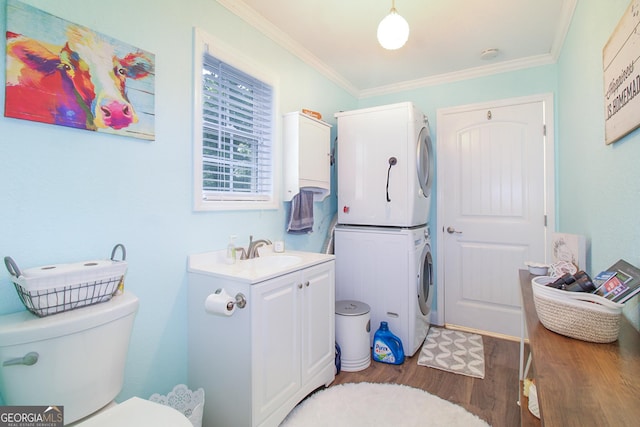 1609 Dillard Bray Rd, Royston, GA 30662 - bathroom with toilet, crown molding, stacked washer / drying machine, and wood finished floors
