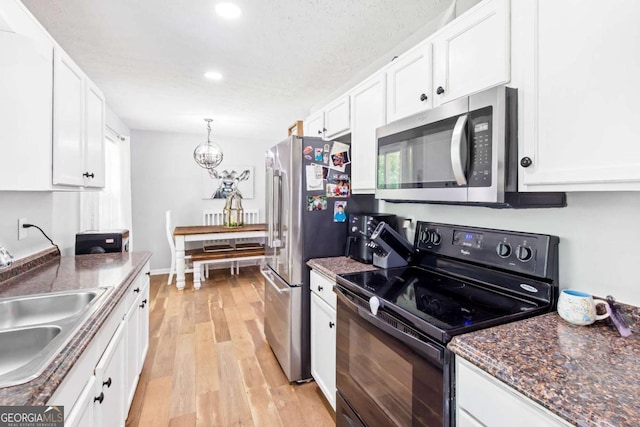 37 Winesap Ct, Temple, GA 30179 - kitchen with appliances with stainless steel finishes, white cabinets, recessed lighting, light wood-style flooring, and a chandelier