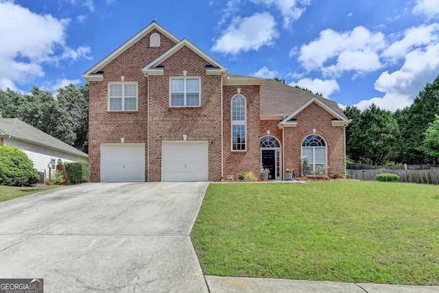view of front of home with driveway, brick siding, fence, an attached garage, and a front yard