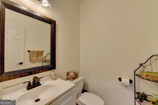 bathroom with toilet and vanity