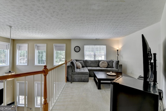 living room with light carpet and a textured ceiling