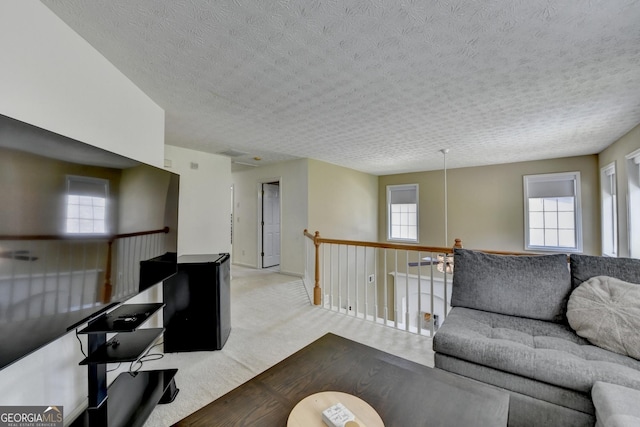 living room with a textured ceiling and carpet floors