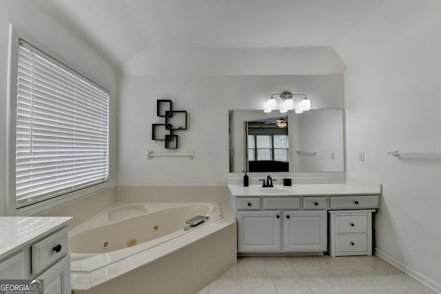 full bathroom featuring a whirlpool tub, vanity, and tile patterned flooring