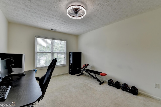 carpeted office space with baseboards, visible vents, and a textured ceiling