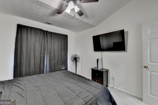 bedroom featuring carpet floors, a textured ceiling, visible vents, baseboards, and ceiling fan