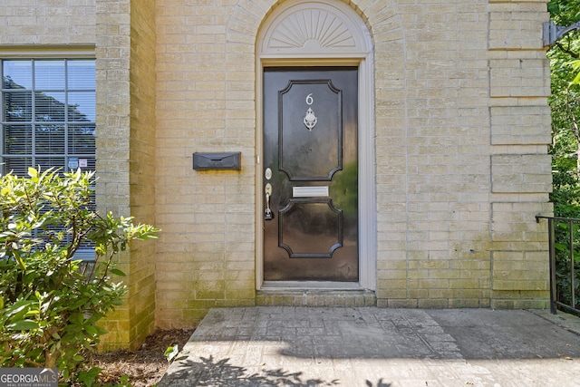 entrance to property with brick siding