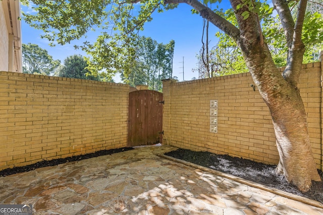 view of patio with a gate and fence