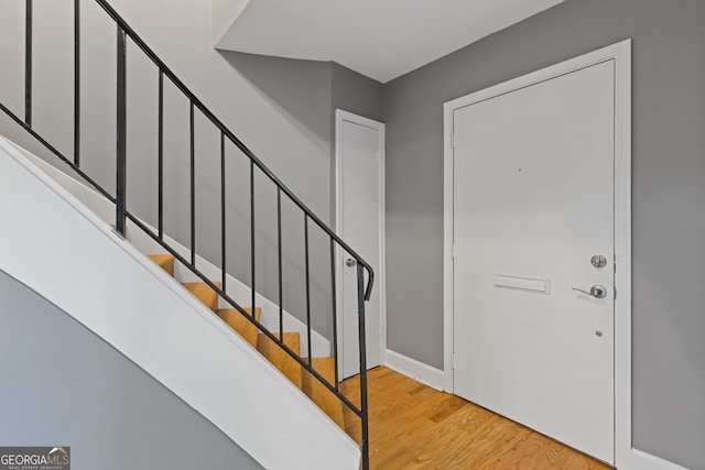 foyer featuring stairway and light wood-style floors