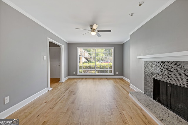 unfurnished living room featuring baseboards, a tile fireplace, ceiling fan, and wood finished floors