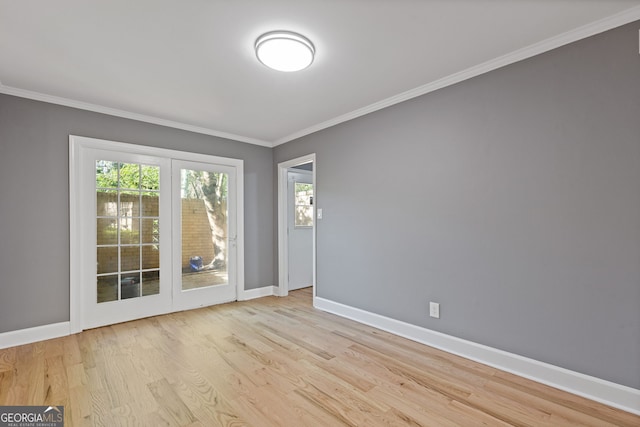 unfurnished room featuring wood finished floors, baseboards, and ornamental molding