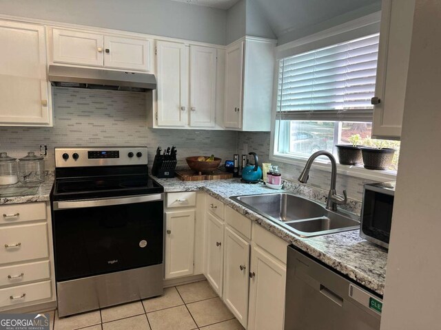 6119 Woodmont Blvd, Peachtree Corners, GA 30092 - kitchen featuring light tile patterned floors, stainless steel appliances, white cabinetry, backsplash, and under cabinet range hood
