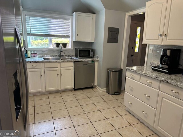 6119 Woodmont Blvd, Peachtree Corners, GA 30092 - kitchen with a sink, under cabinet range hood, white cabinetry, light tile patterned floors, and appliances with stainless steel finishes