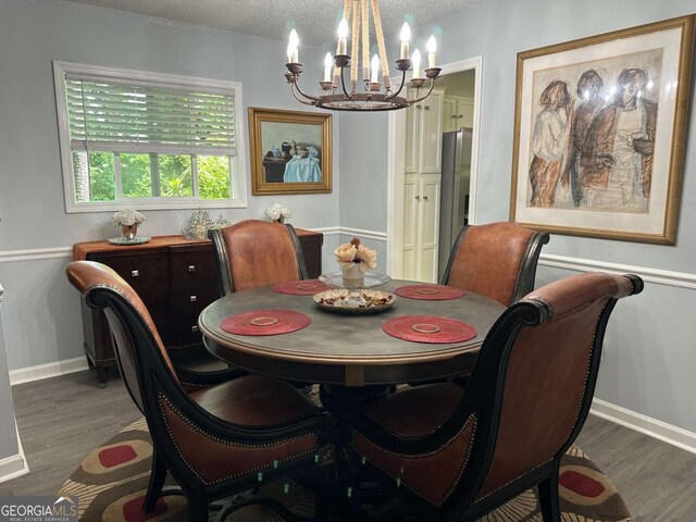 6119 Woodmont Blvd, Peachtree Corners, GA 30092 - dining area with wood finished floors, a textured ceiling, baseboards, visible vents, and a notable chandelier