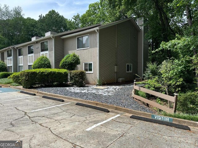 6119 Woodmont Blvd, Peachtree Corners, GA 30092 - exterior space with uncovered parking and a chimney